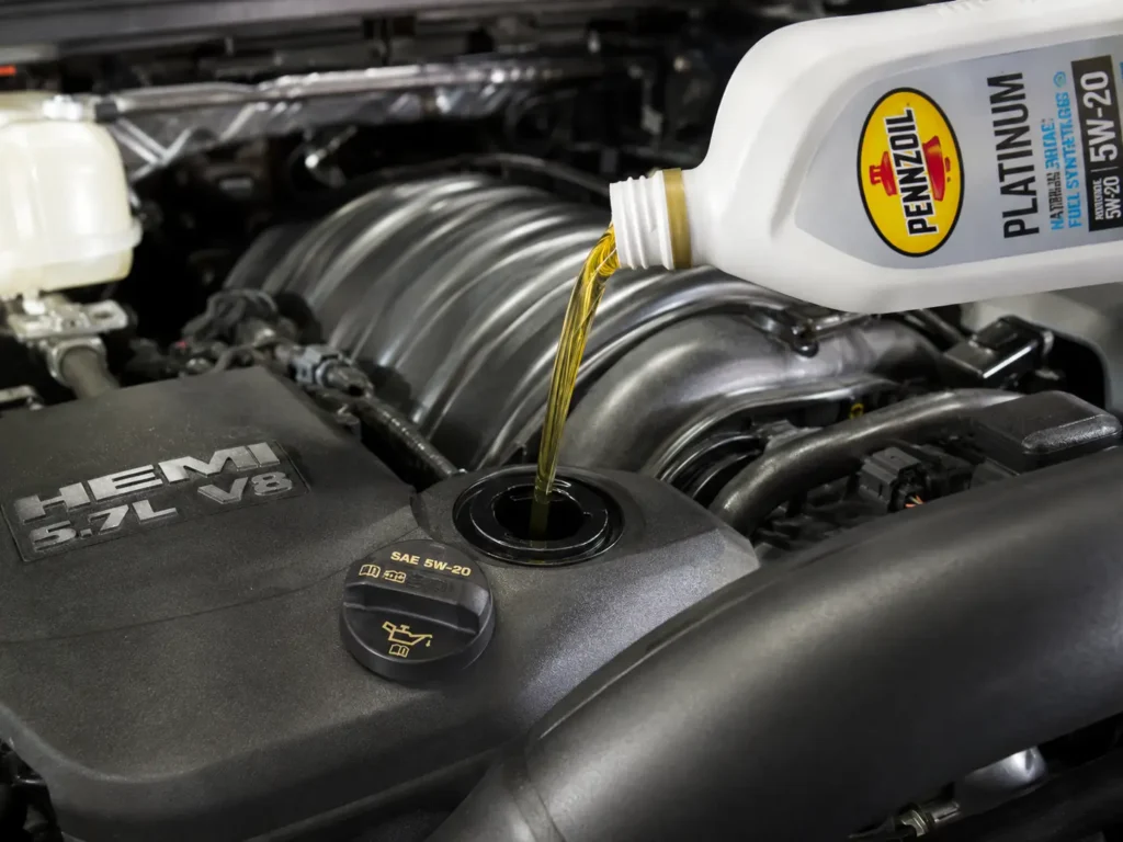 2020 Ram 1500 5.7 HEMI engine bay with oil cap open during an oil change procedure