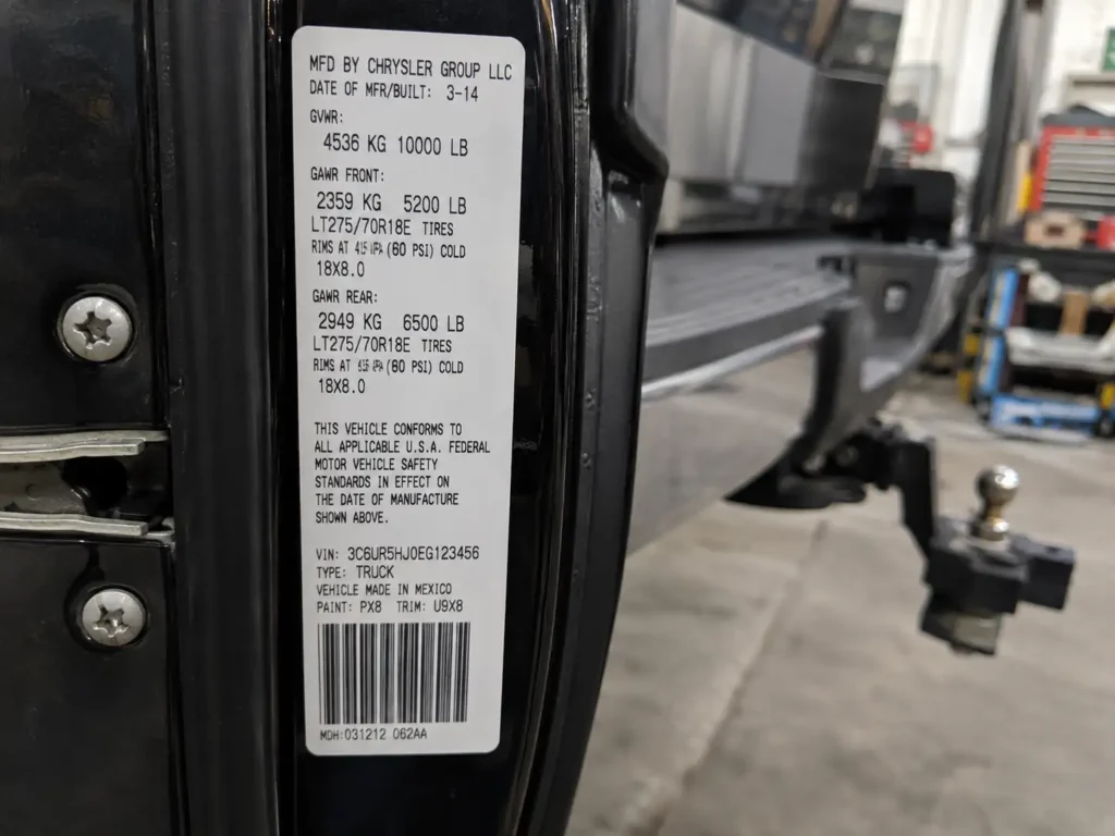 Door jamb sticker showing 2014 Ram 2500 towing capacity rating