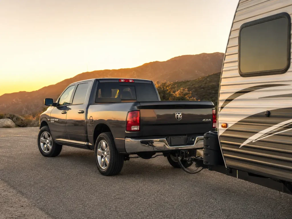 2011 Ram 1500 towing a travel trailer on the highway