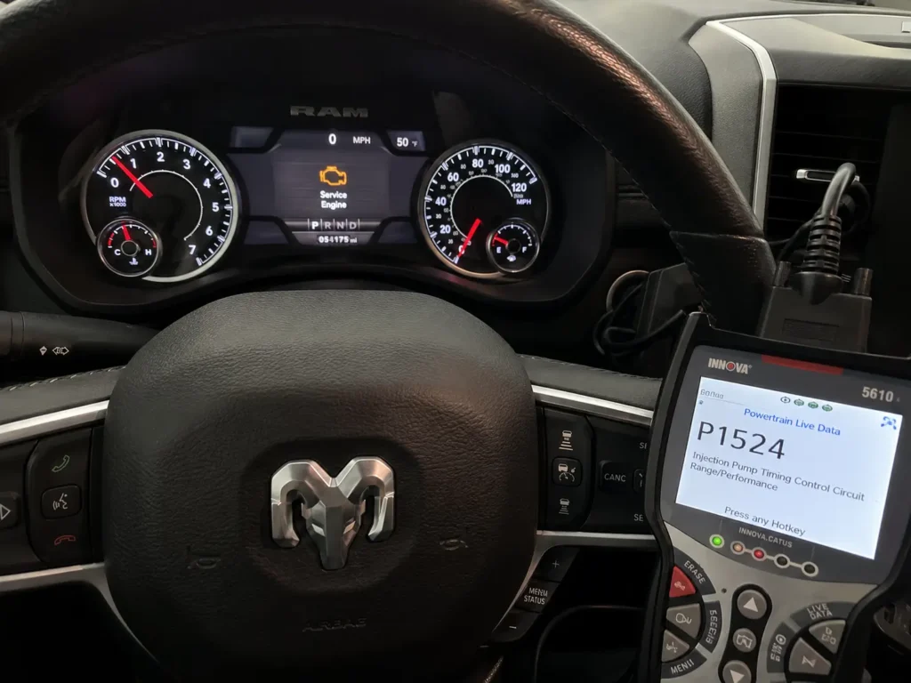 2021 Ram 1500 dashboard with check engine light illuminated and an OBD2 scan tool displaying diagnostic trouble code P1524.