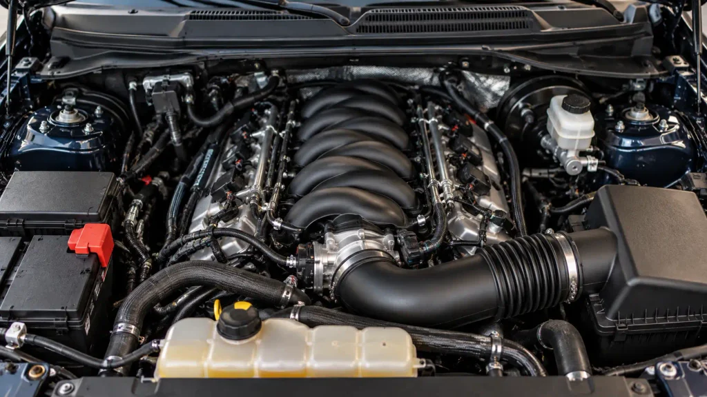 Ford F-150 5.0 Coyote V8 engine bay with intake manifold and wiring harness