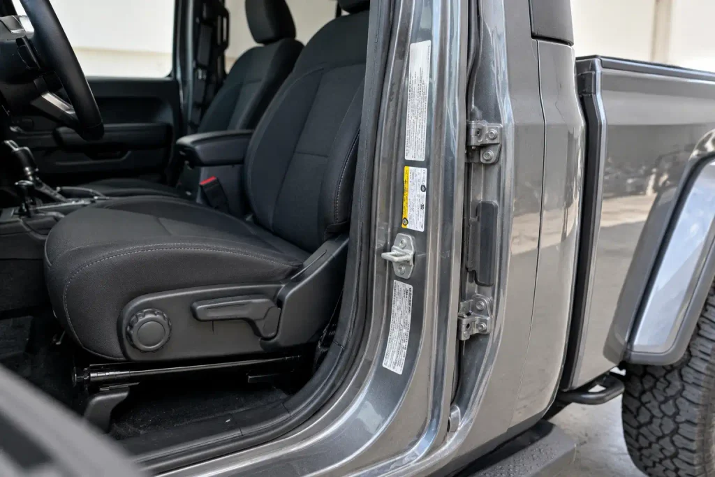 Open Jeep Gladiator driver door showing location of payload and certification labels