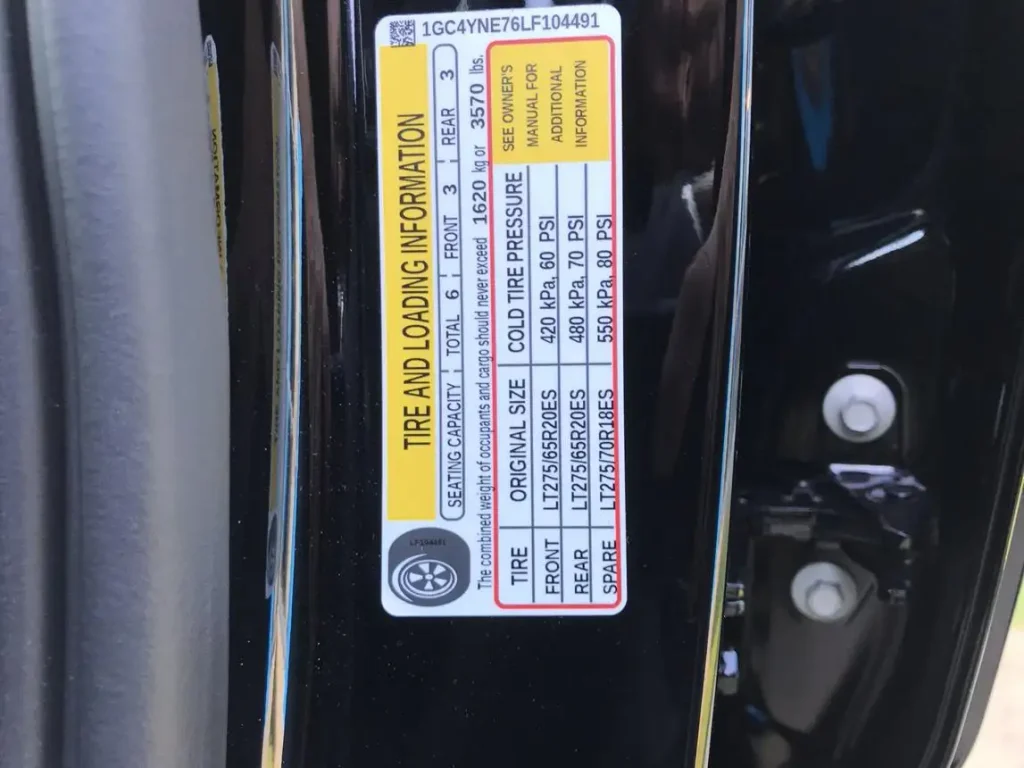 Silverado 2500HD driver door jamb showing factory loading label locations